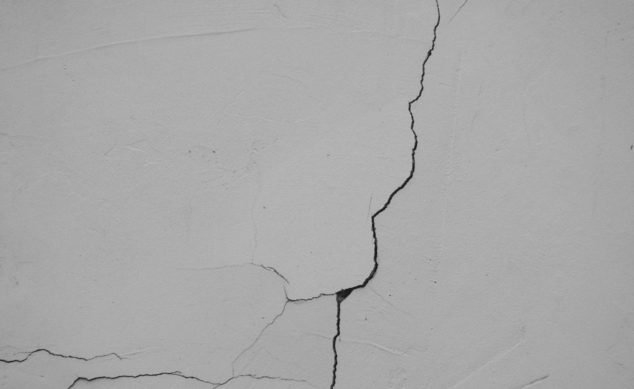 a crack in the side of a white wall