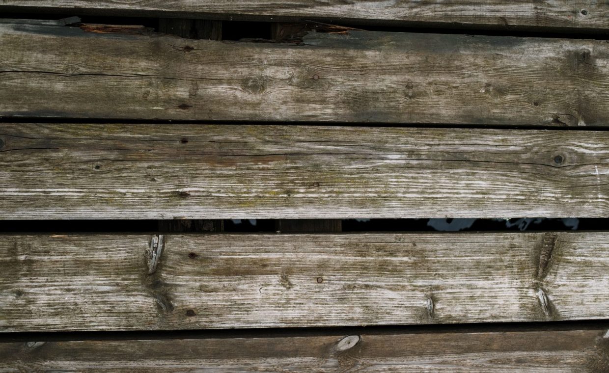 Close-up of rustic wooden planks with a natural texture, ideal for backgrounds.