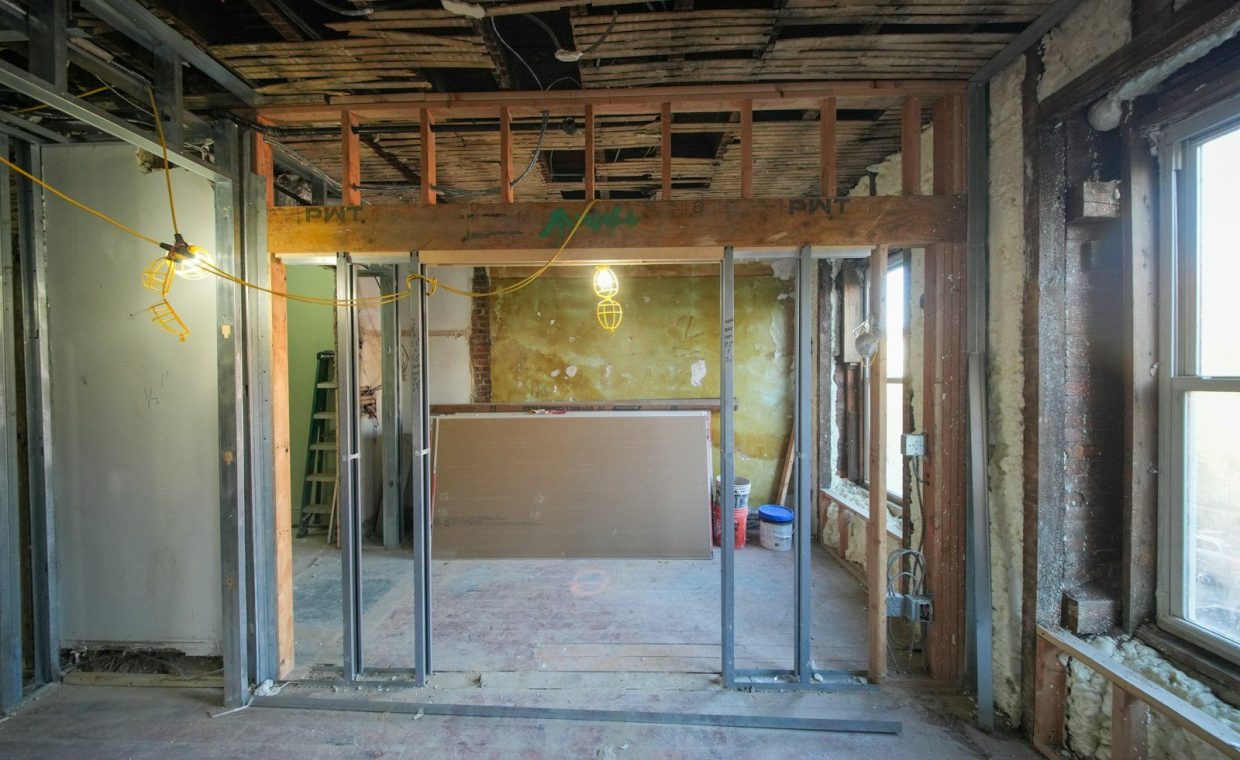 Interior room under construction with metal studs.