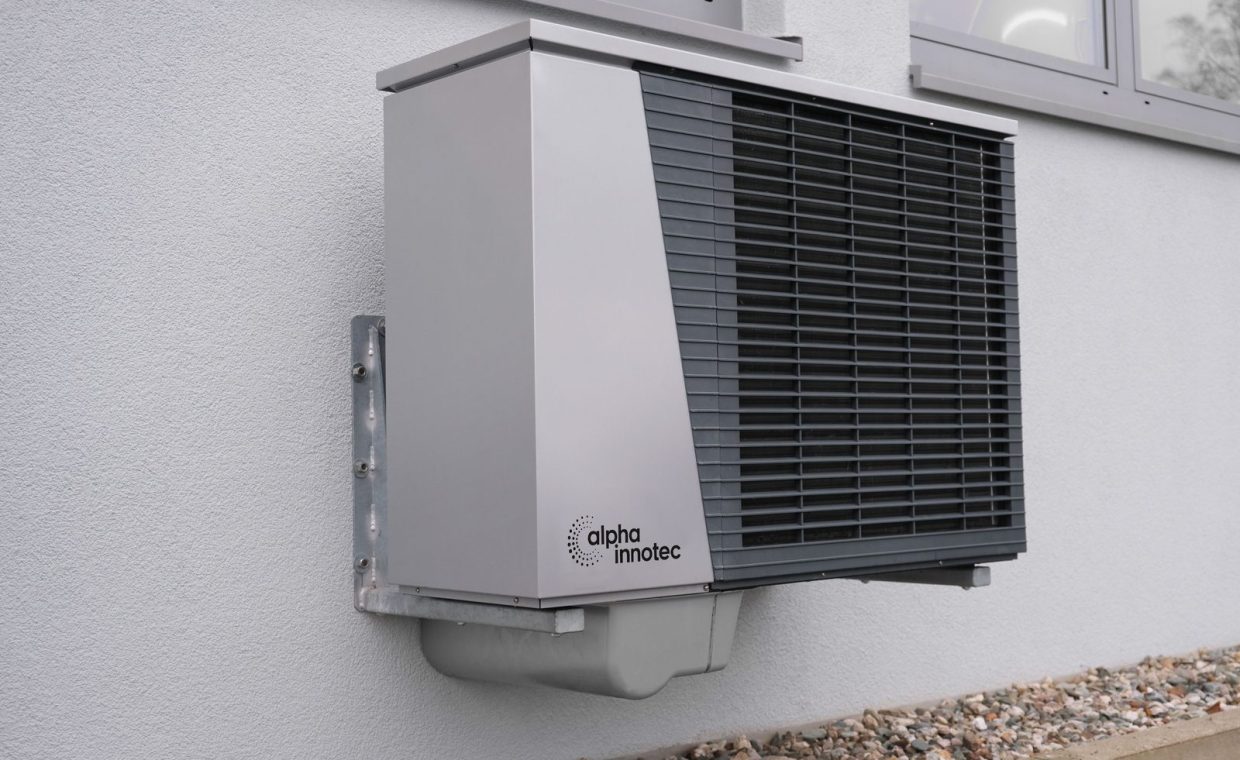 Outdoor air conditioning unit mounted on a residential building exterior.
