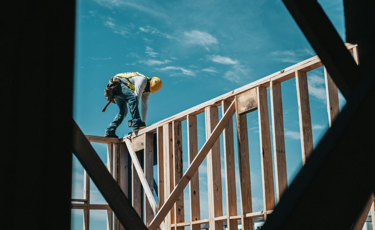 construction worker in hard hat on building frame
