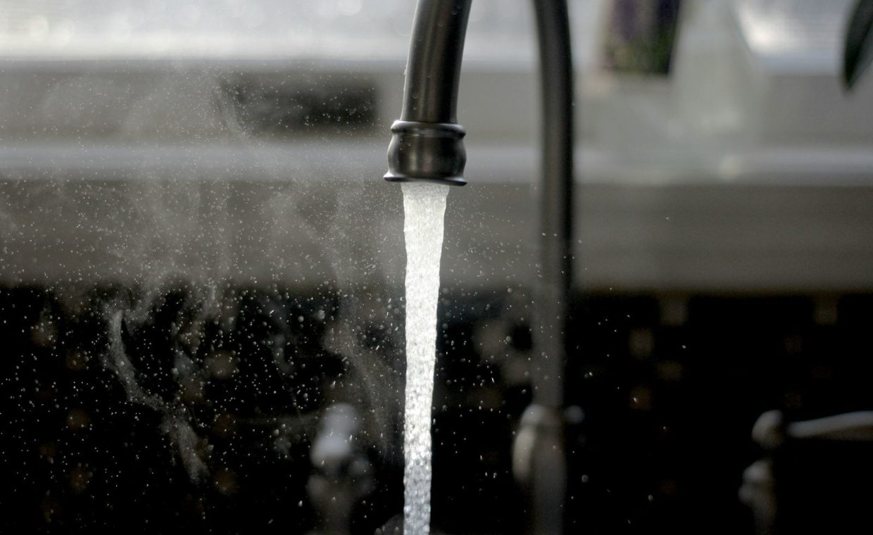 a faucet running water from a kitchen sink