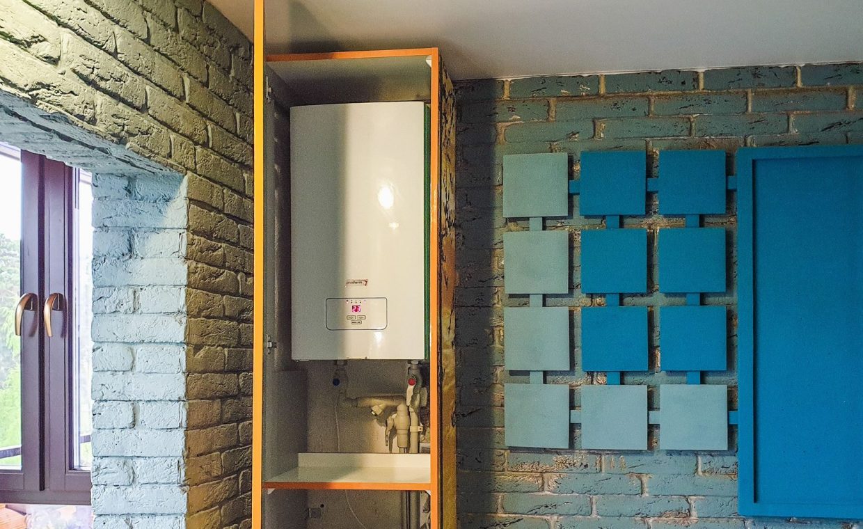 Indoor view of a water heater neatly installed in a cabinet with modern decor.
